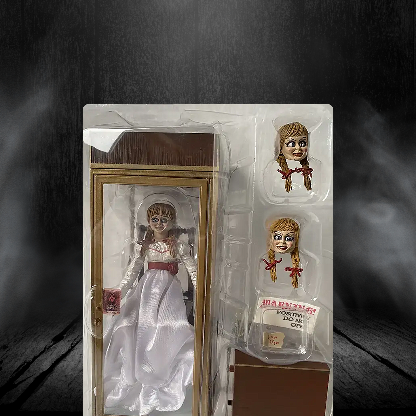 Horror-themed doll in packaging with a dark, smoky background