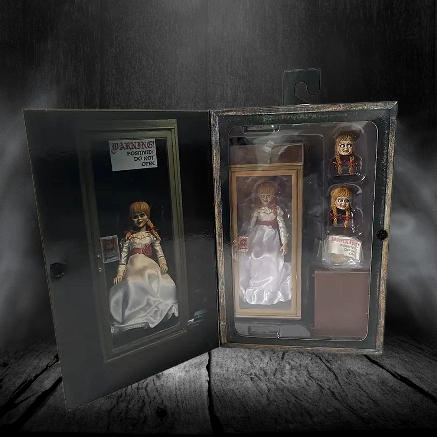 Set of dolls in packaging on a wooden surface with a dark background