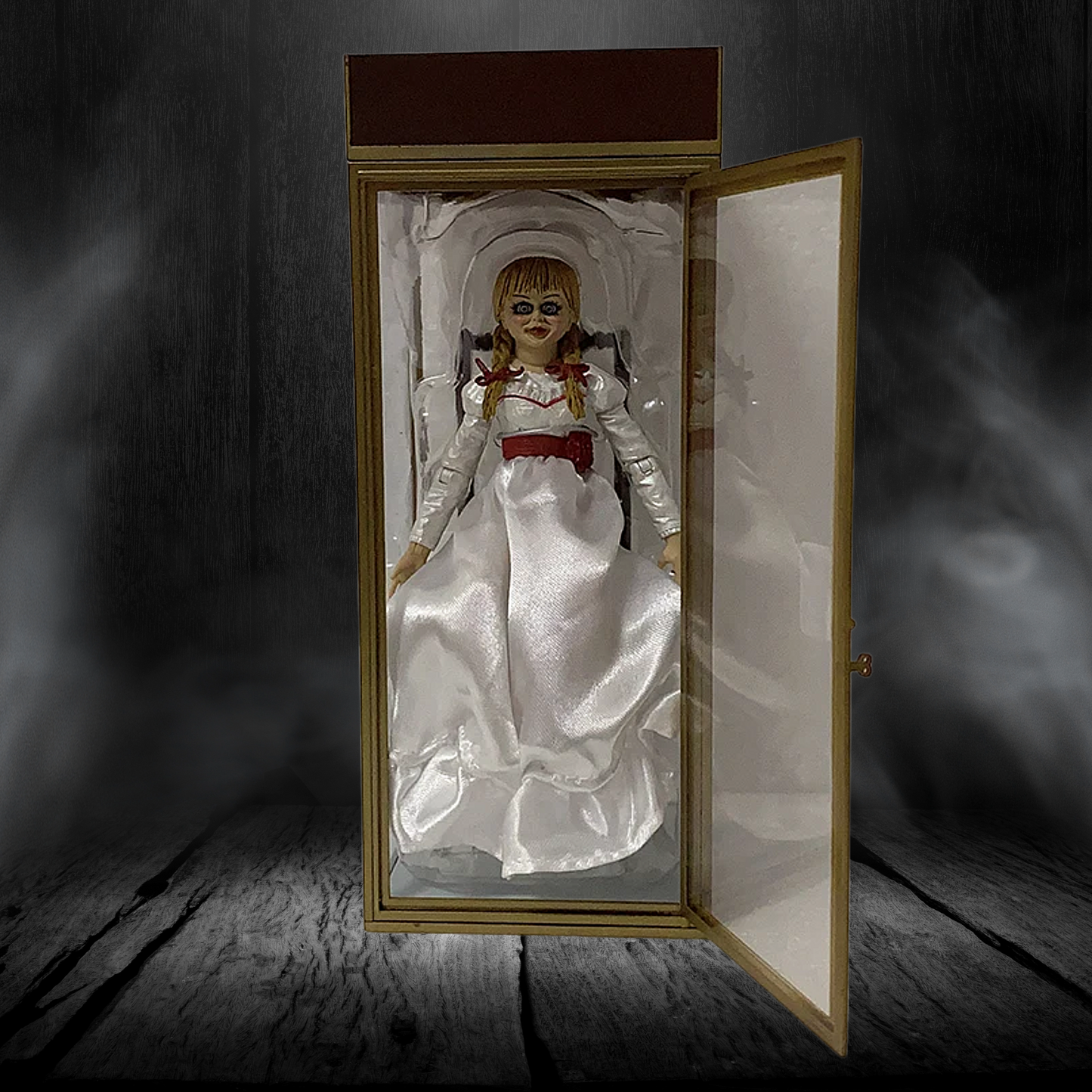 Horror-themed doll in a glass case with a dark, smoky background