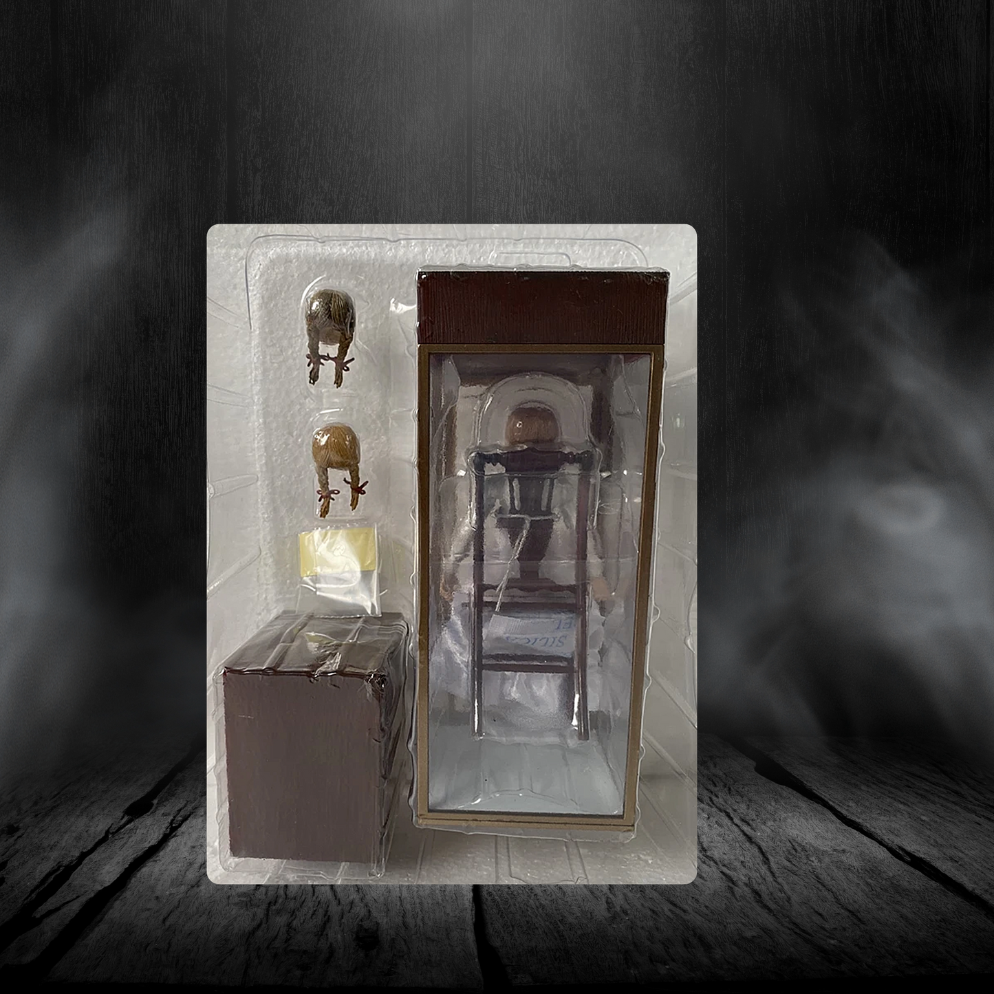 Model of a chair in packaging on a dark wooden surface