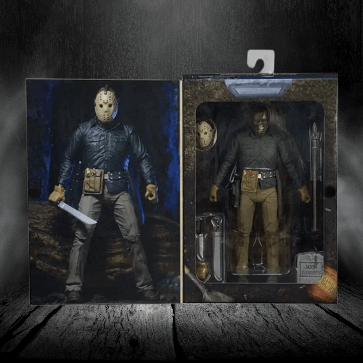 Two action figure packages on a wooden surface with a dark background