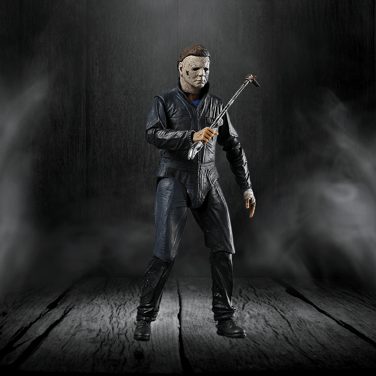 Action figure in a dark setting holding a weapon