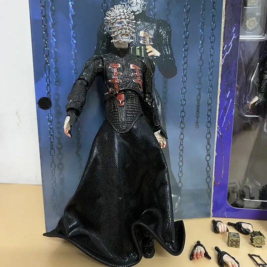 Action figure in a black outfit with intricate details, standing against a blue chain-link background.