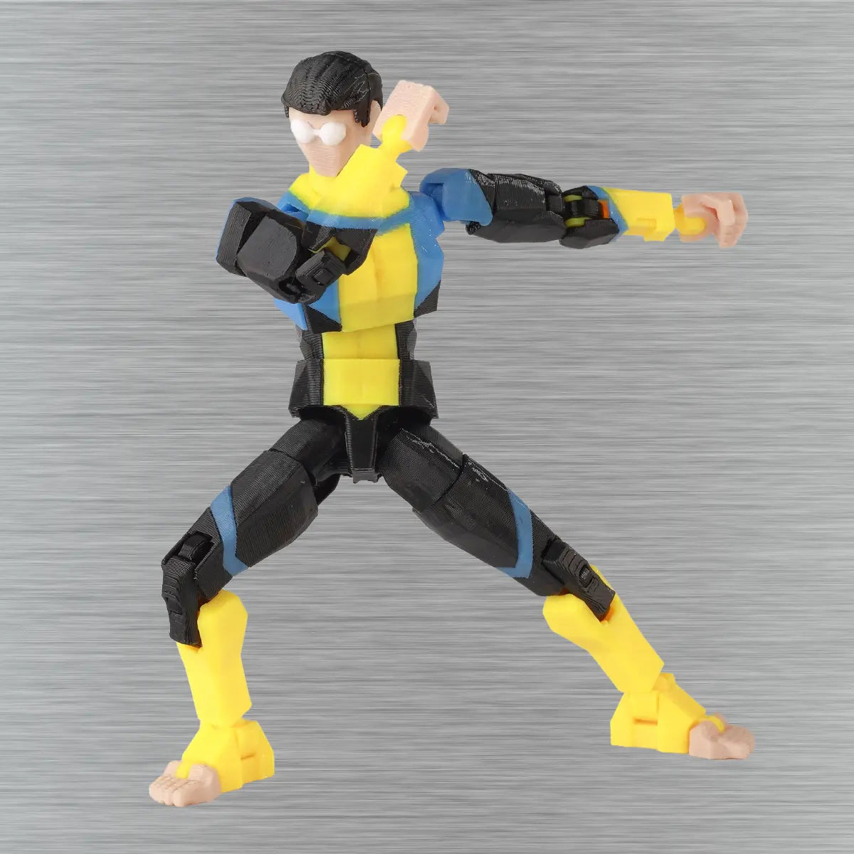 Action figure in yellow and black outfit on a gray background