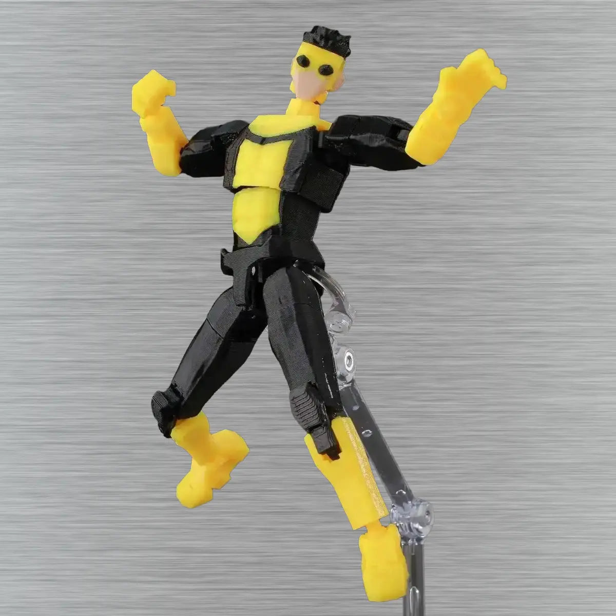 Toy figure with yellow and black design on a textured gray background