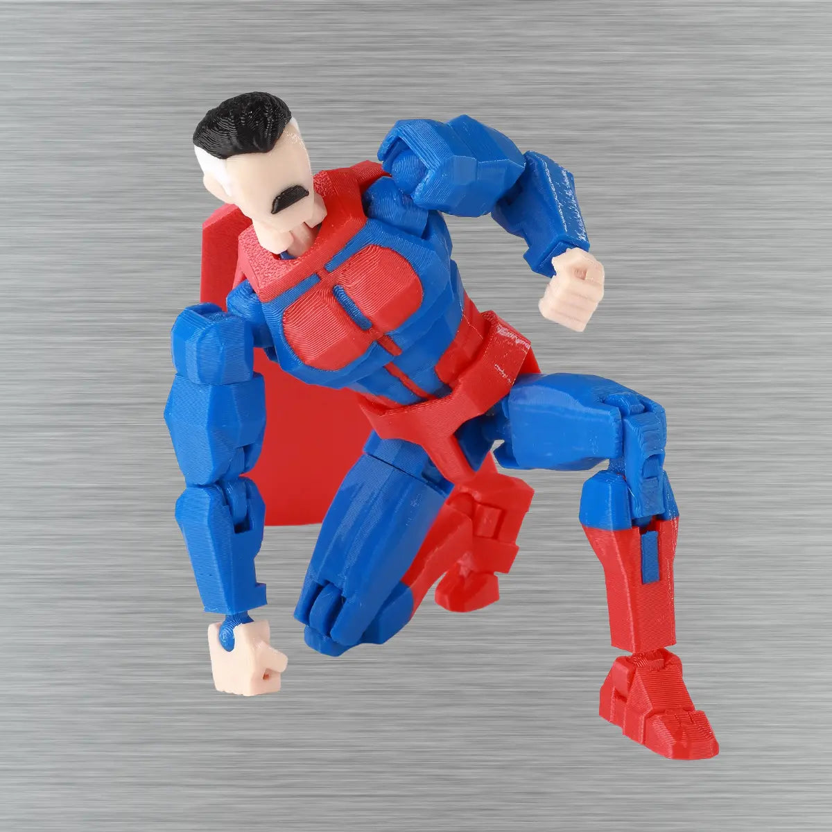 Toy figure in blue and red costume on a textured gray background