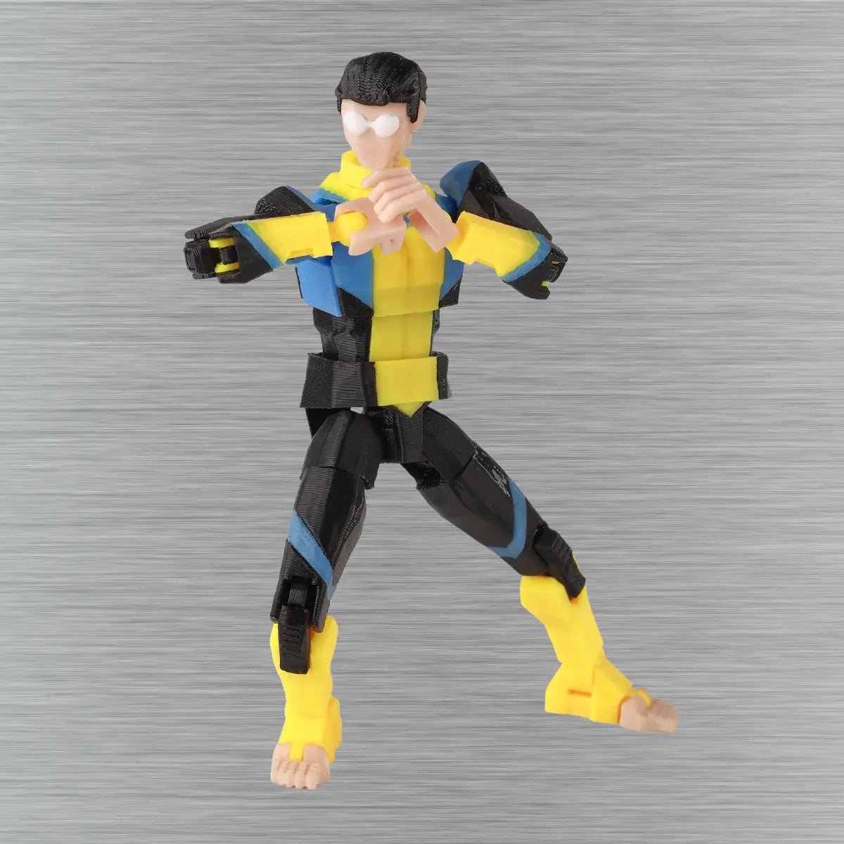 Action figure in yellow and black costume on a gray background