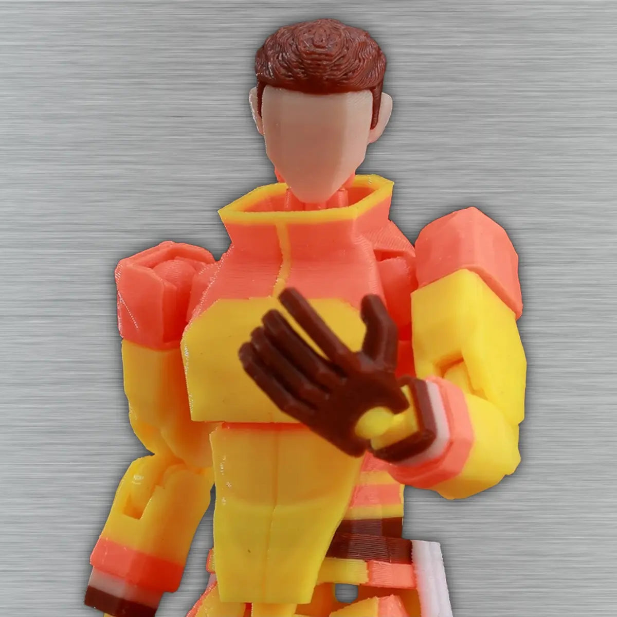Colorful toy figure with a red and yellow outfit on a gray background