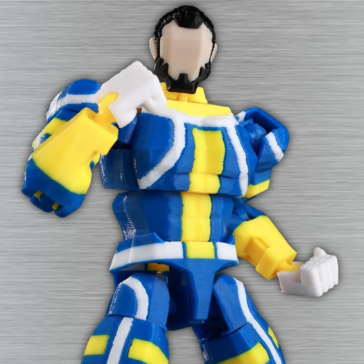 Toy figure with blue and yellow outfit on a textured gray background
