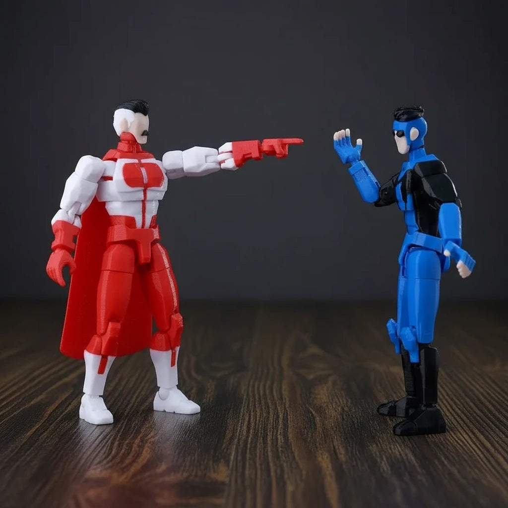 Two action figures, one red and white, the other blue and black, on a gray background.