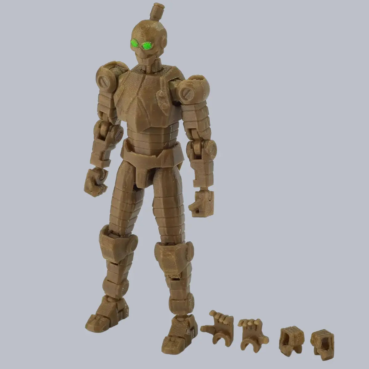 Toy robot figure with green eyes on a gray background