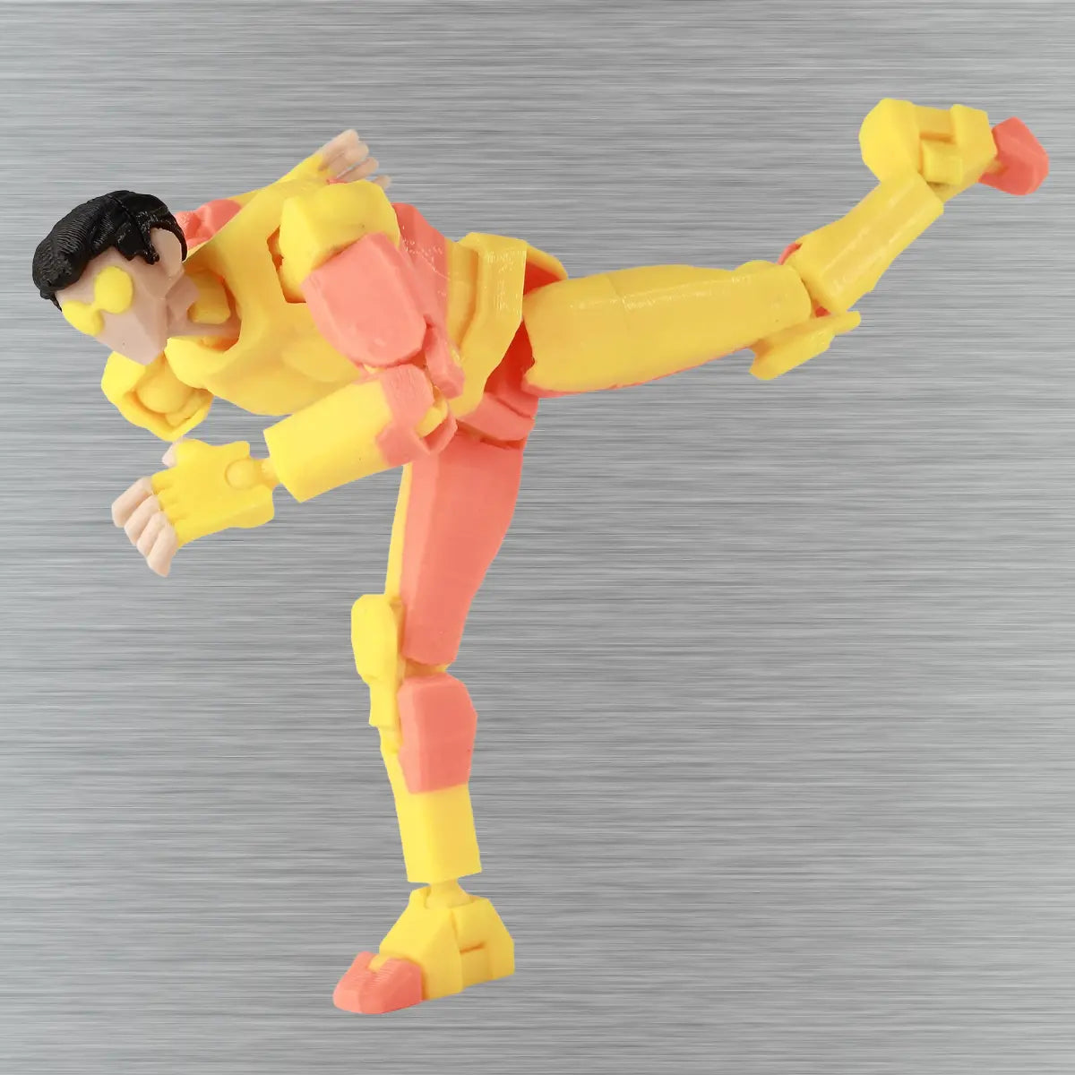 Action figure in yellow and red on a textured gray background