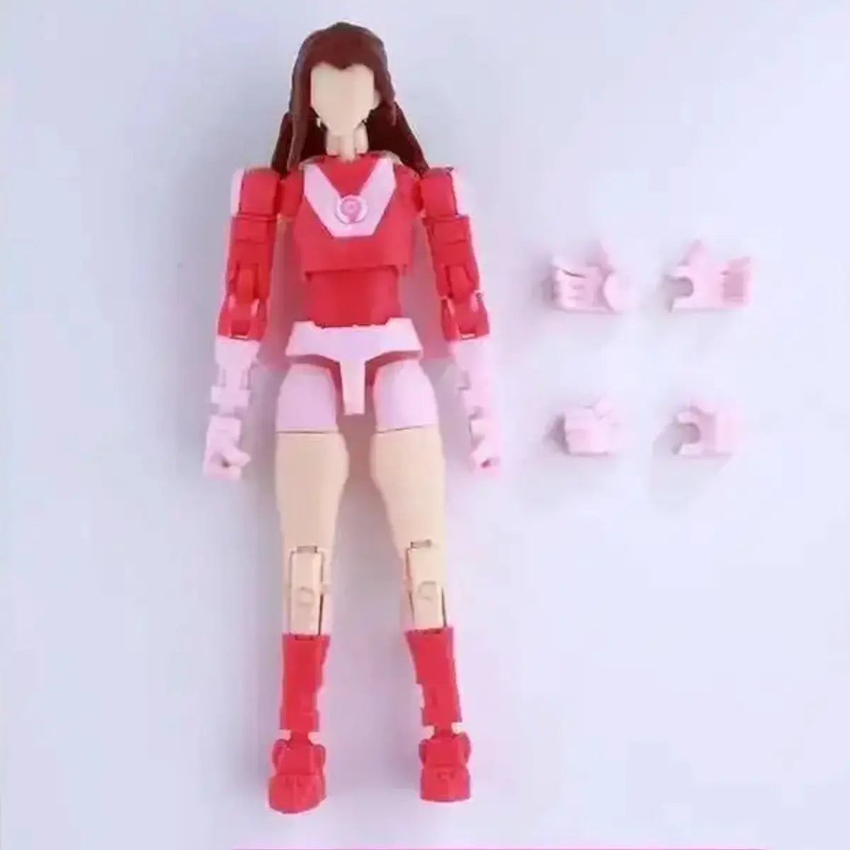 Action figure in red and pink costume with detached parts on a light gray background