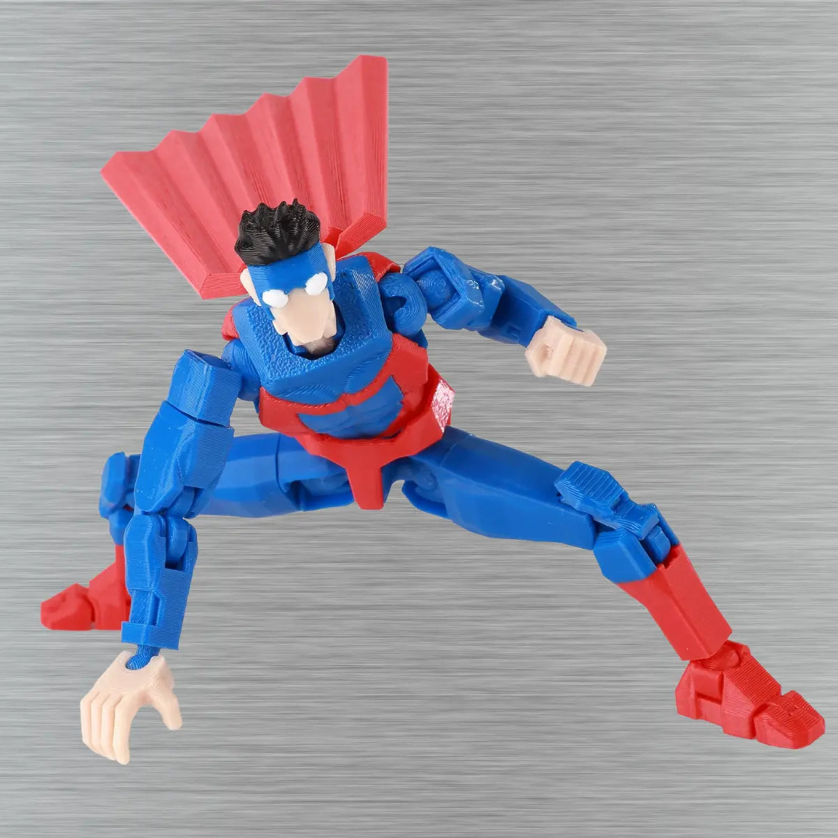 Toy figure in blue and red costume on a textured gray background