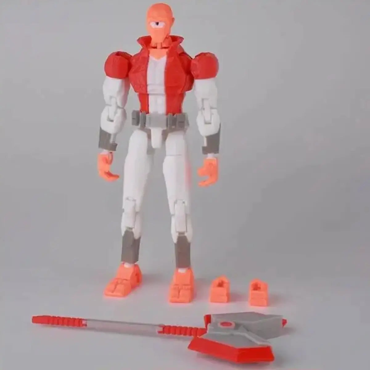 Action figure with red, white, and gray color scheme on a gray background