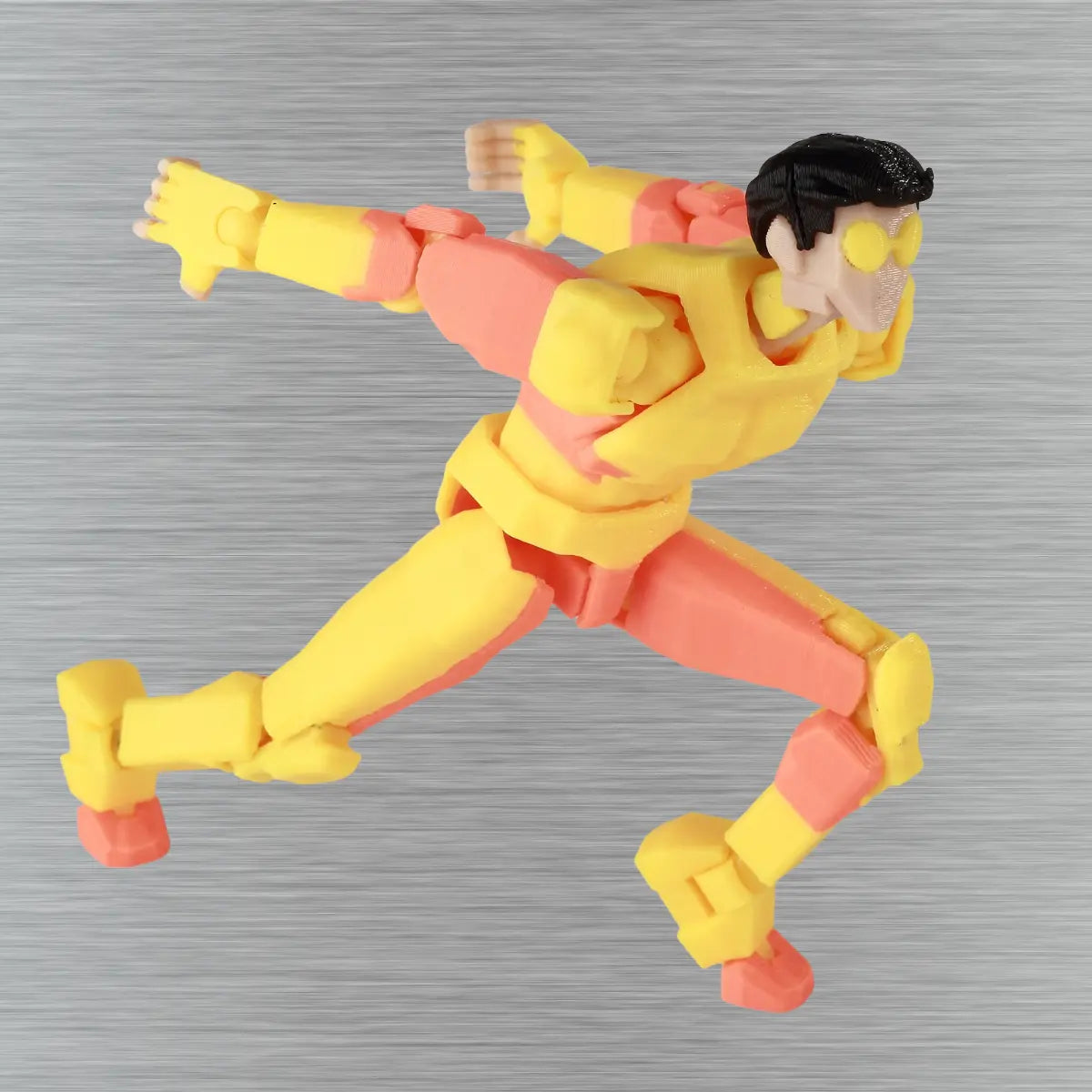 Action figure in yellow and red on a textured gray background
