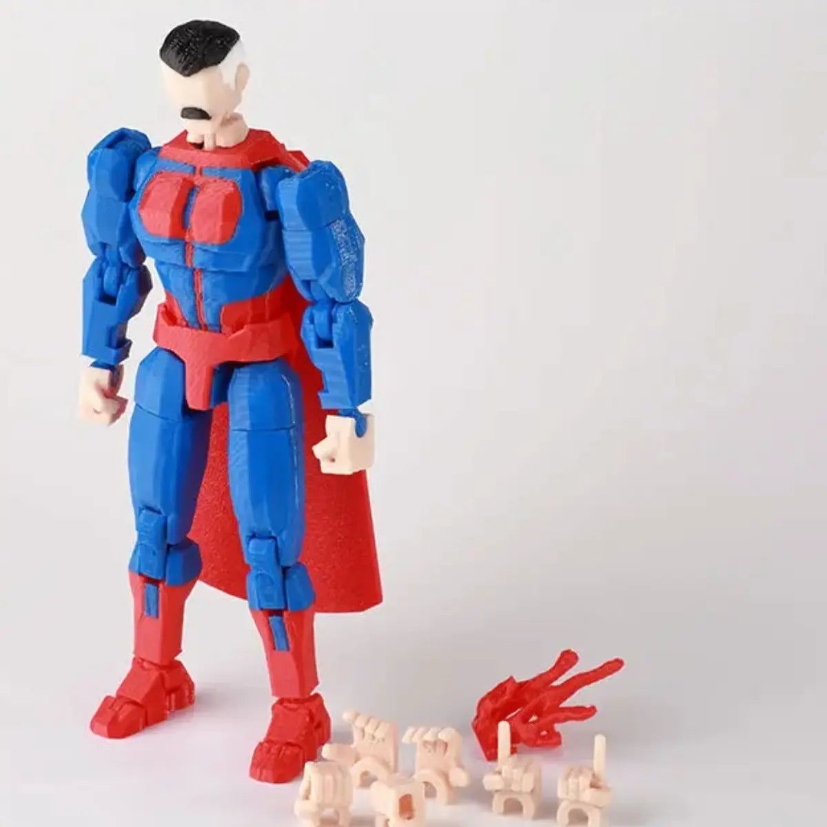 Superhero action figure with red and blue costume on a white background
