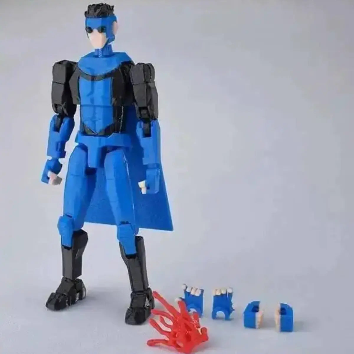 Blue superhero action figure with accessories on a gray background