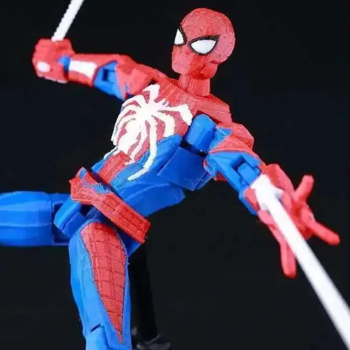 Spider-Man action figure in red and blue costume on a black background