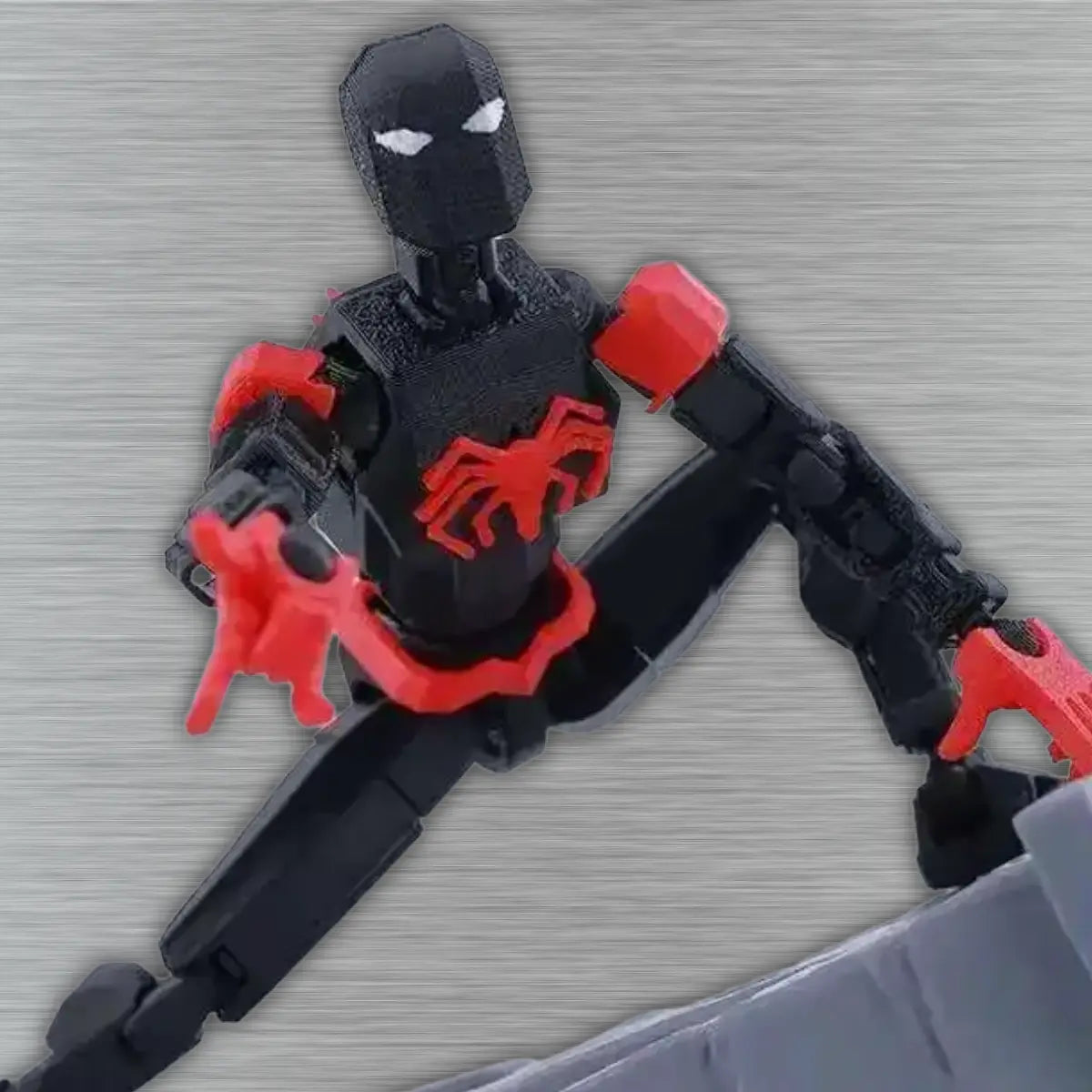 Black and red toy figure on a textured gray surface