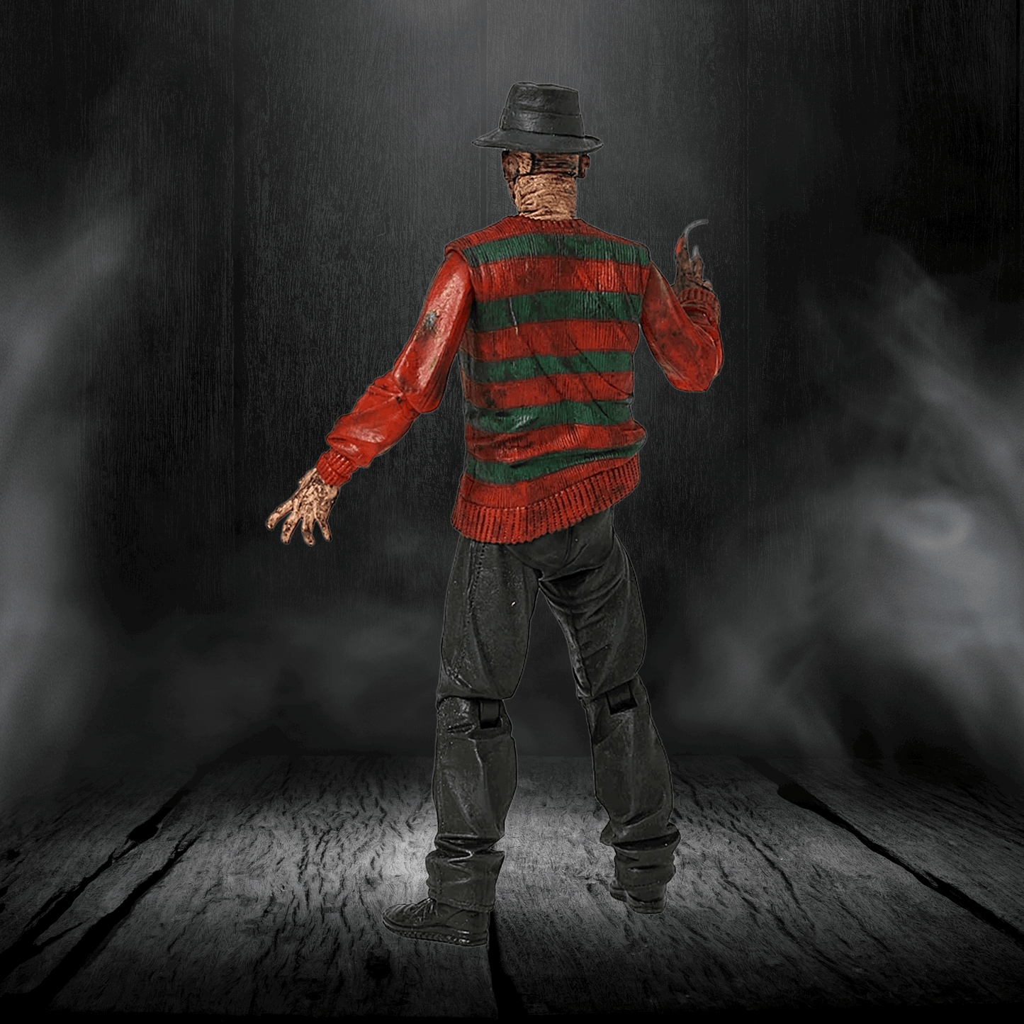 Character in a red and green striped sweater with a hat, holding a knife, on a dark background.