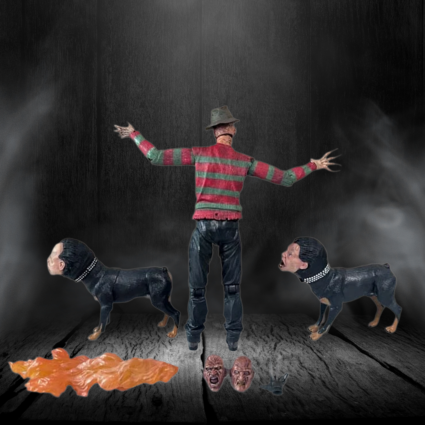 Man in striped sweater with arms outstretched between two dogs on a dark background
