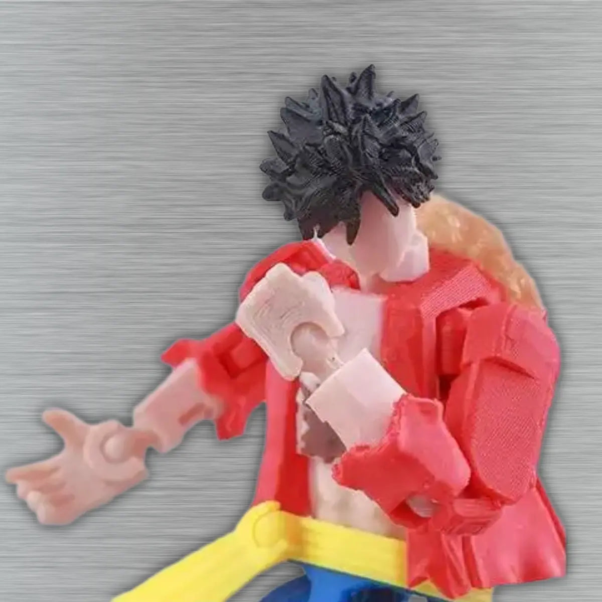 Toy figure with red outfit and black hair on a textured gray background