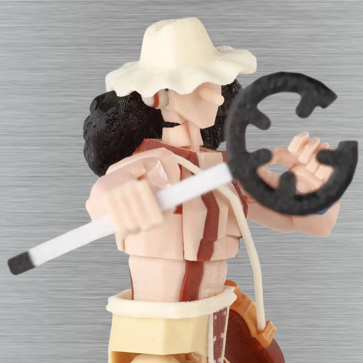 Action figure with a large letter 'C' on a gray background