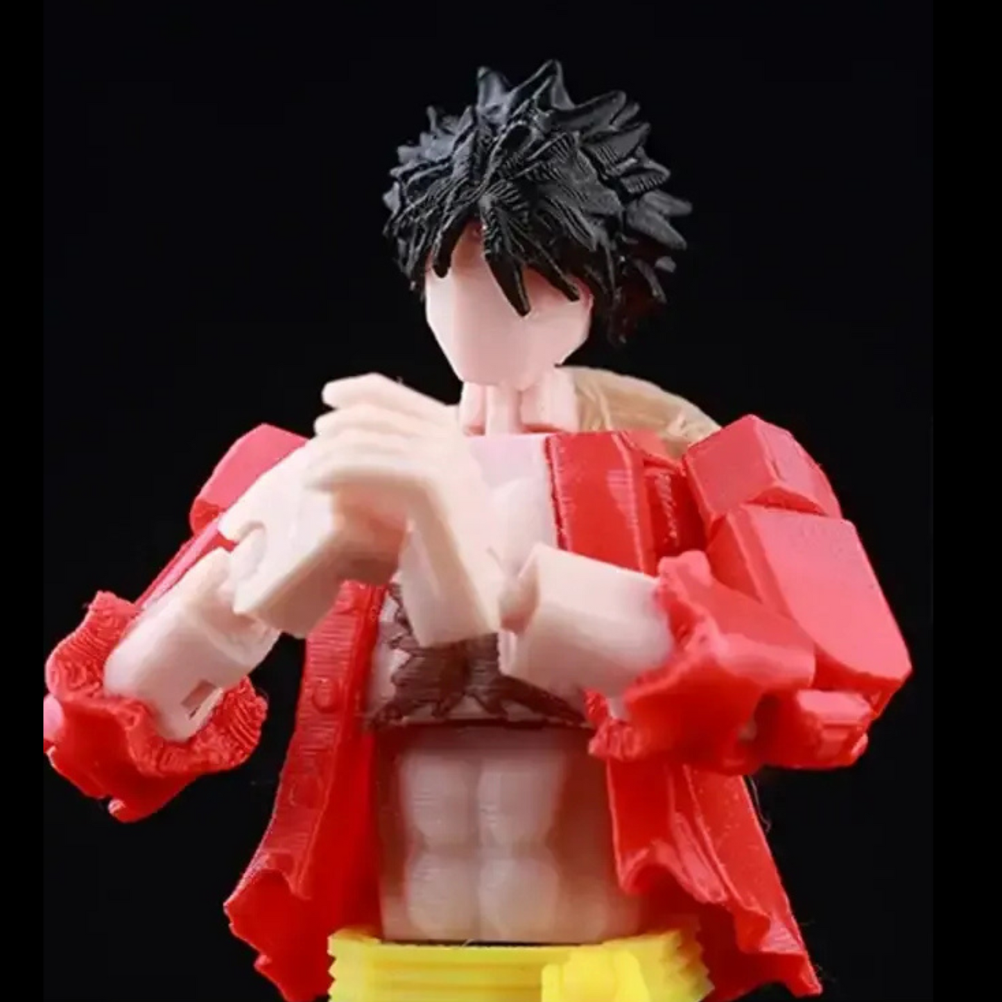 Action figure with red outfit and black hair on a black background