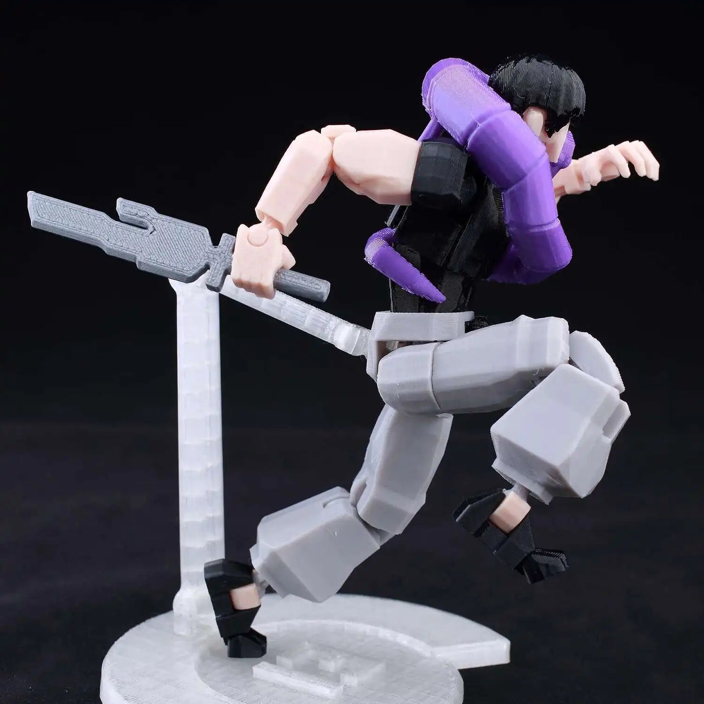 Action figure in dynamic pose with purple and black outfit on a dark background