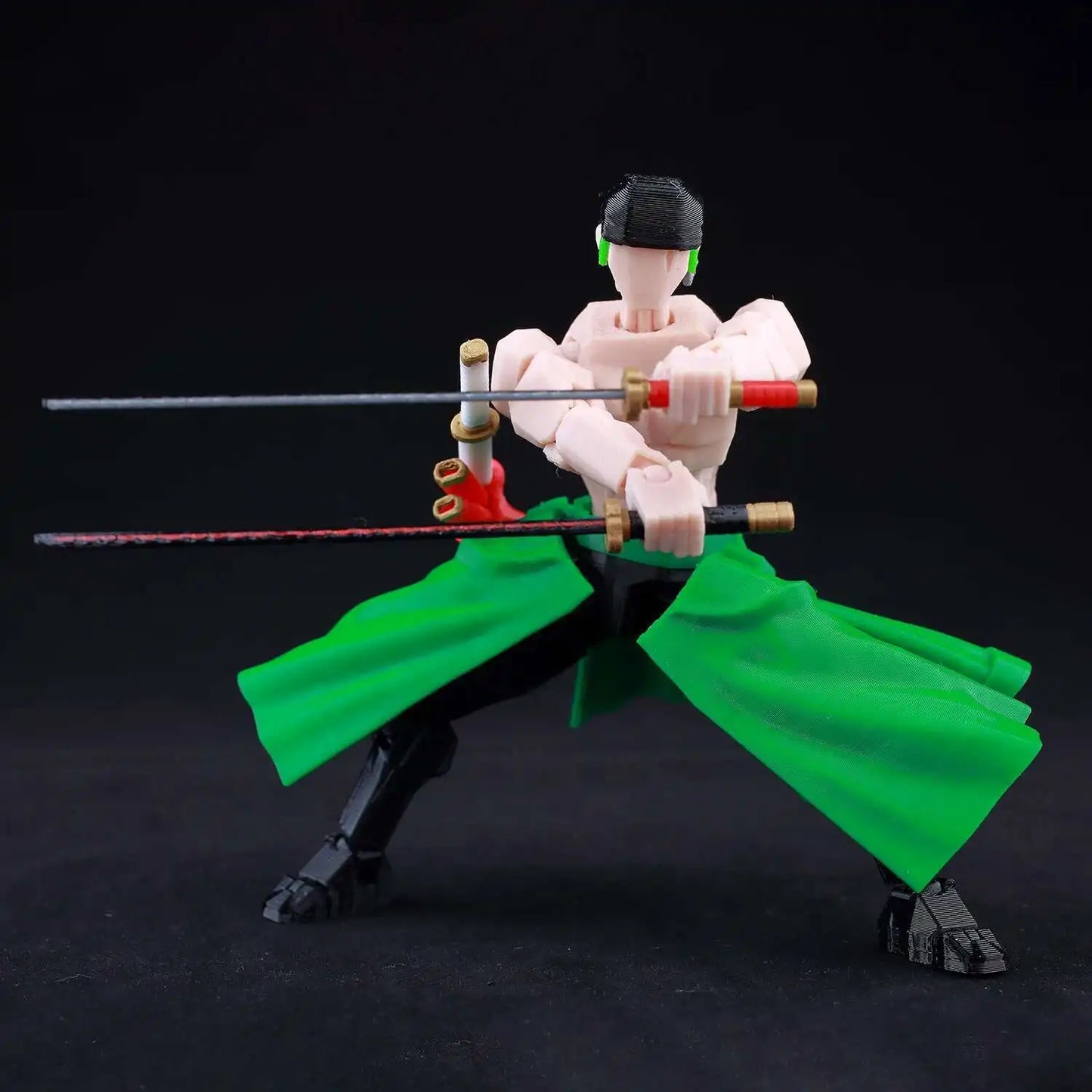Action figure with green cape and sword on a black background