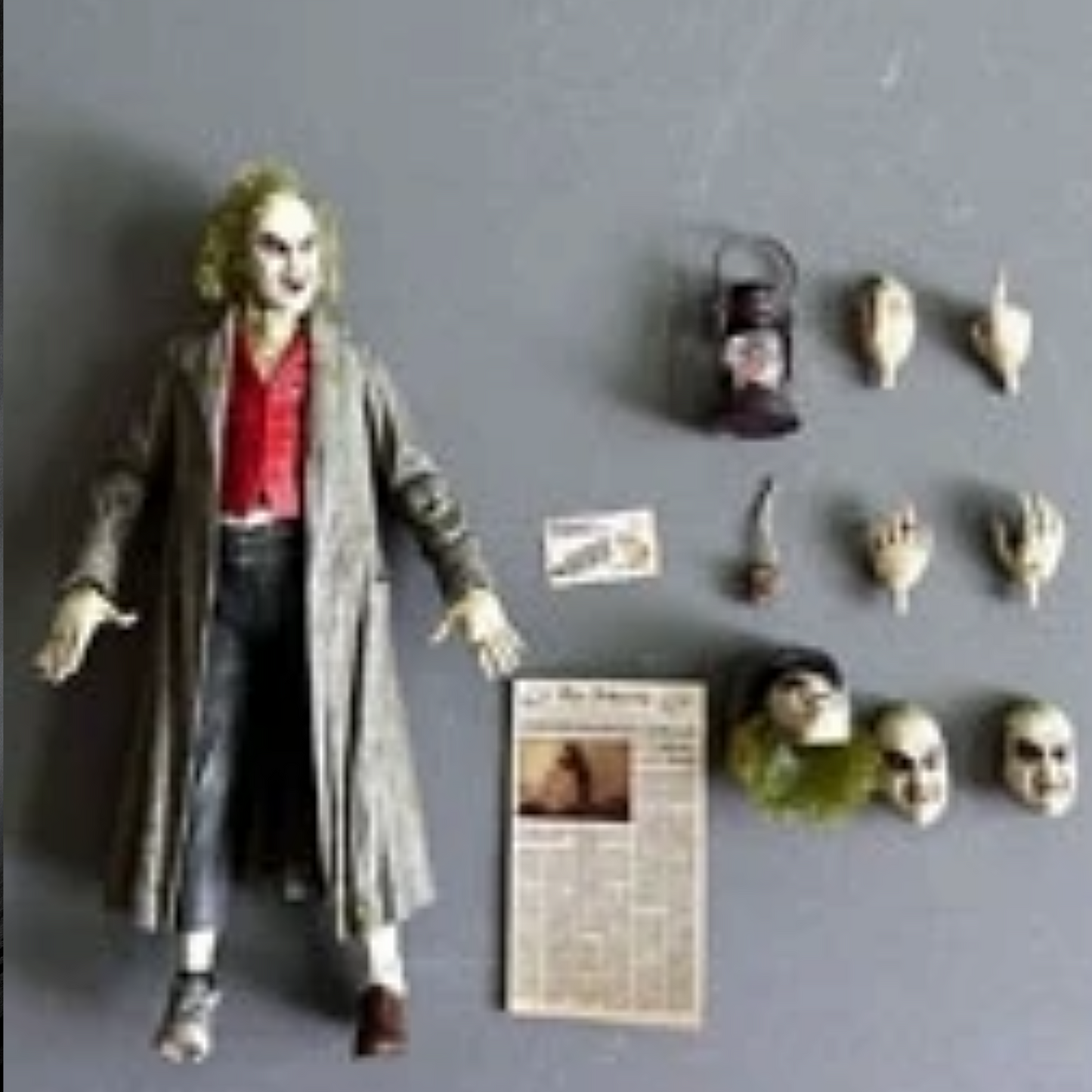 Action figure of a character with accessories on a gray background