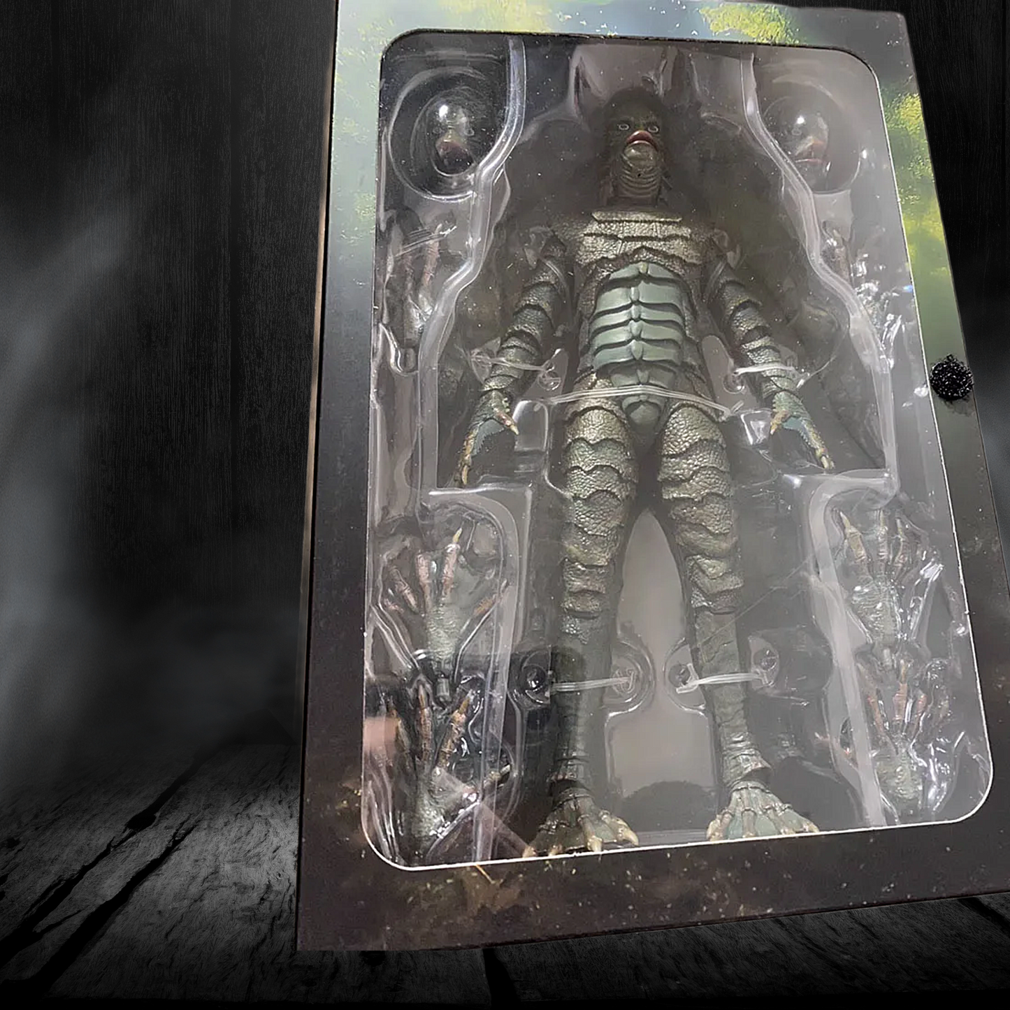 Action figure in clear packaging on a dark surface