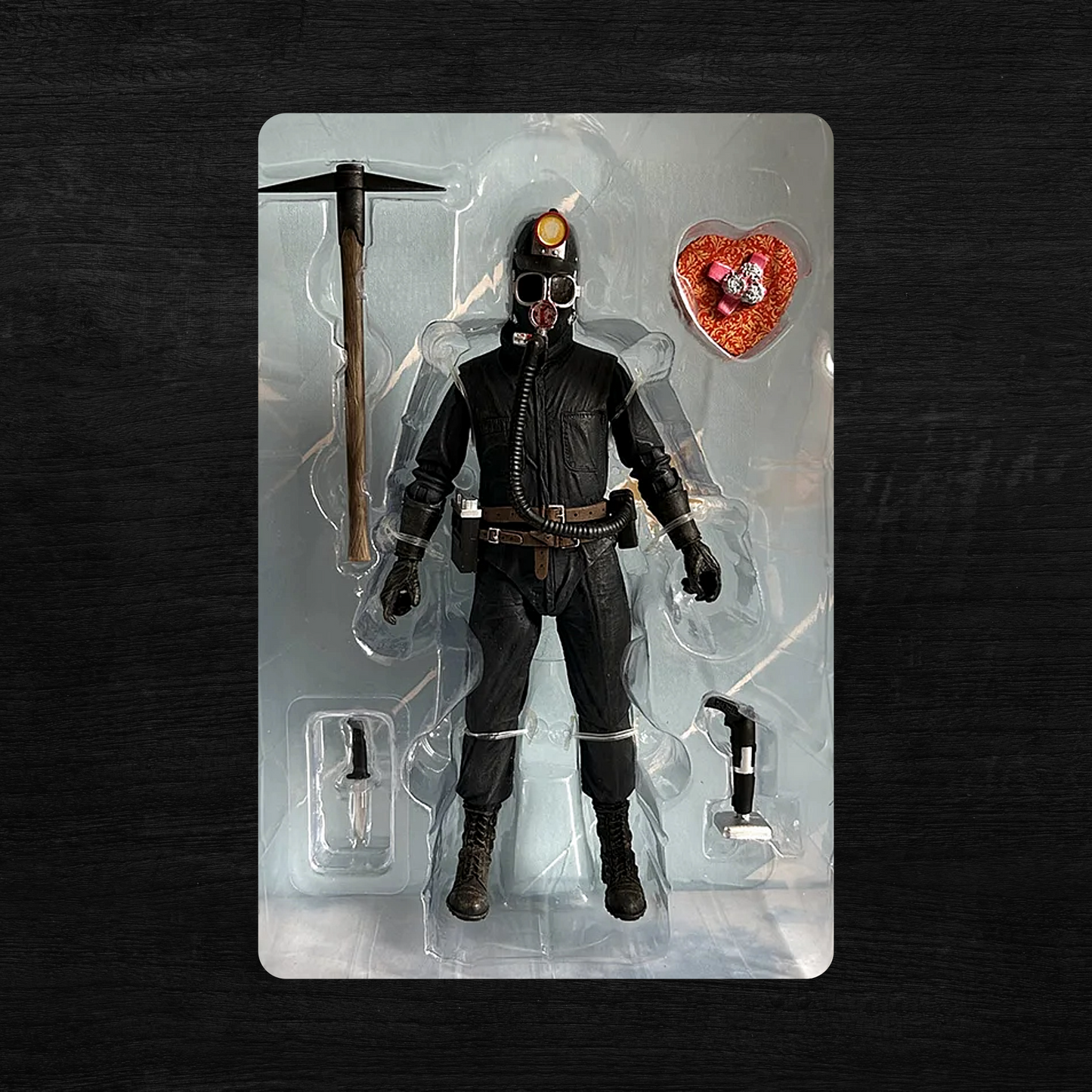 Action figure in a clear plastic packaging on a dark background