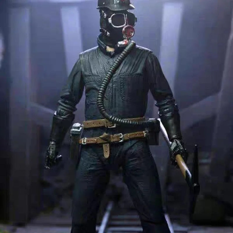 Action figure in a dark uniform with a gas mask and weapon, standing against a dark background.