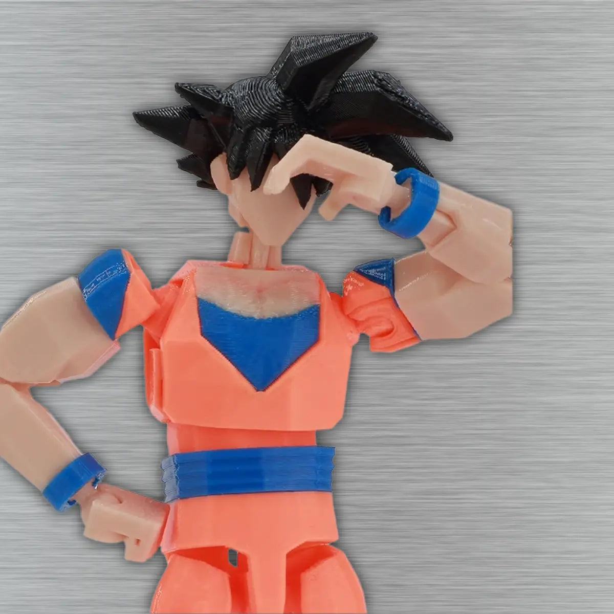 Toy figure of a character in an orange and blue outfit on a textured gray background