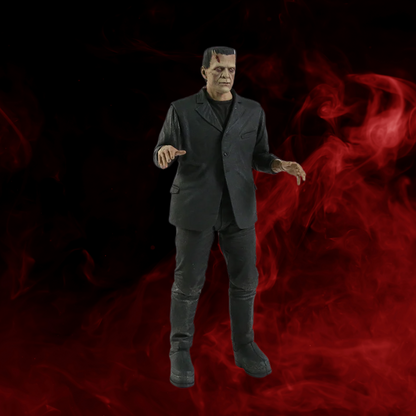 Action figure of a character in a black suit against a red and black background