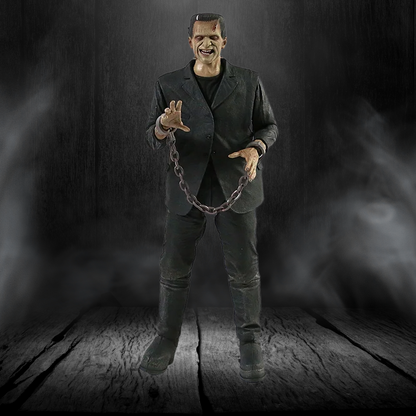 Mannequin of a character in a dark suit holding chains against a dark background