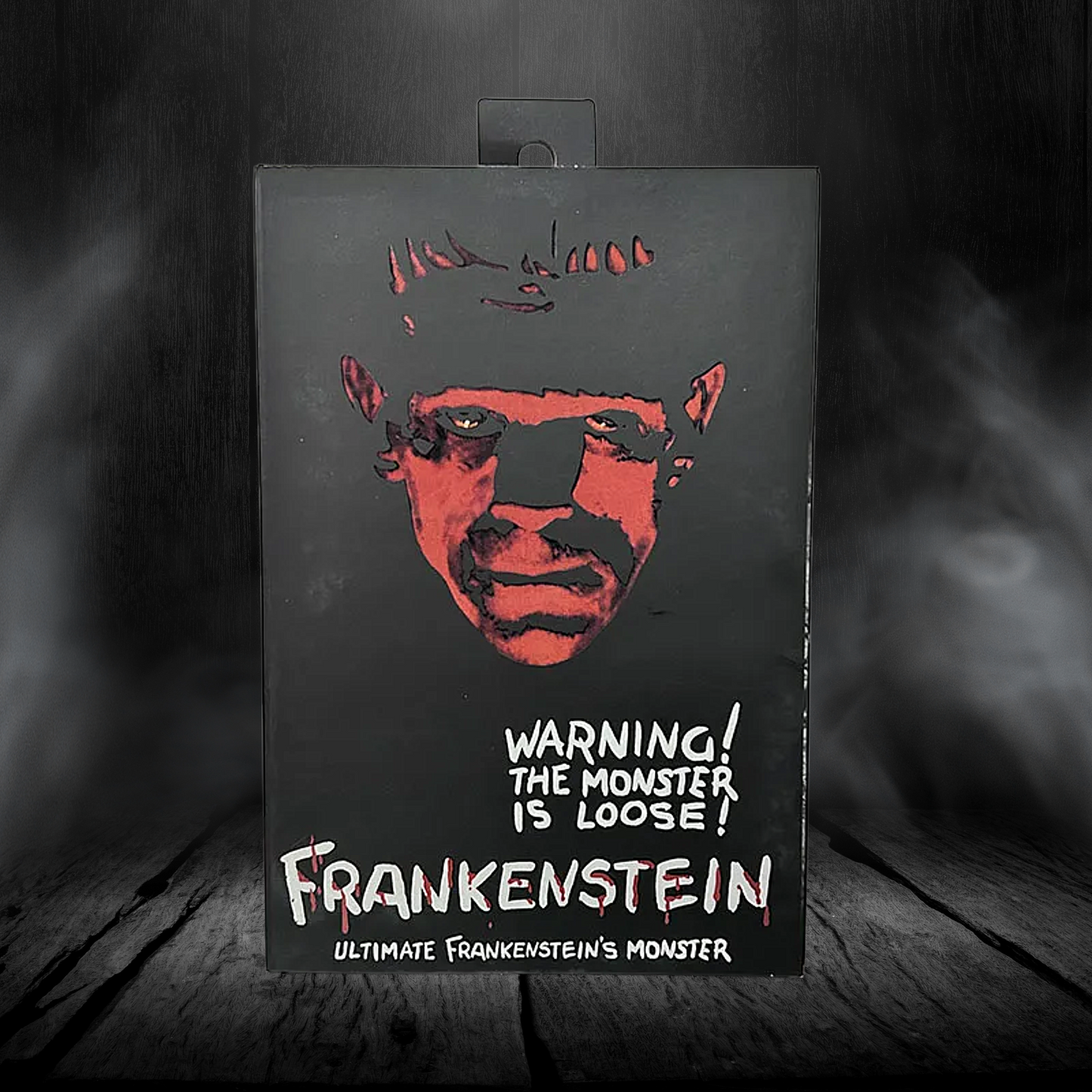 Product packaging with a stylized illustration of a monster's face and text on a dark background.
