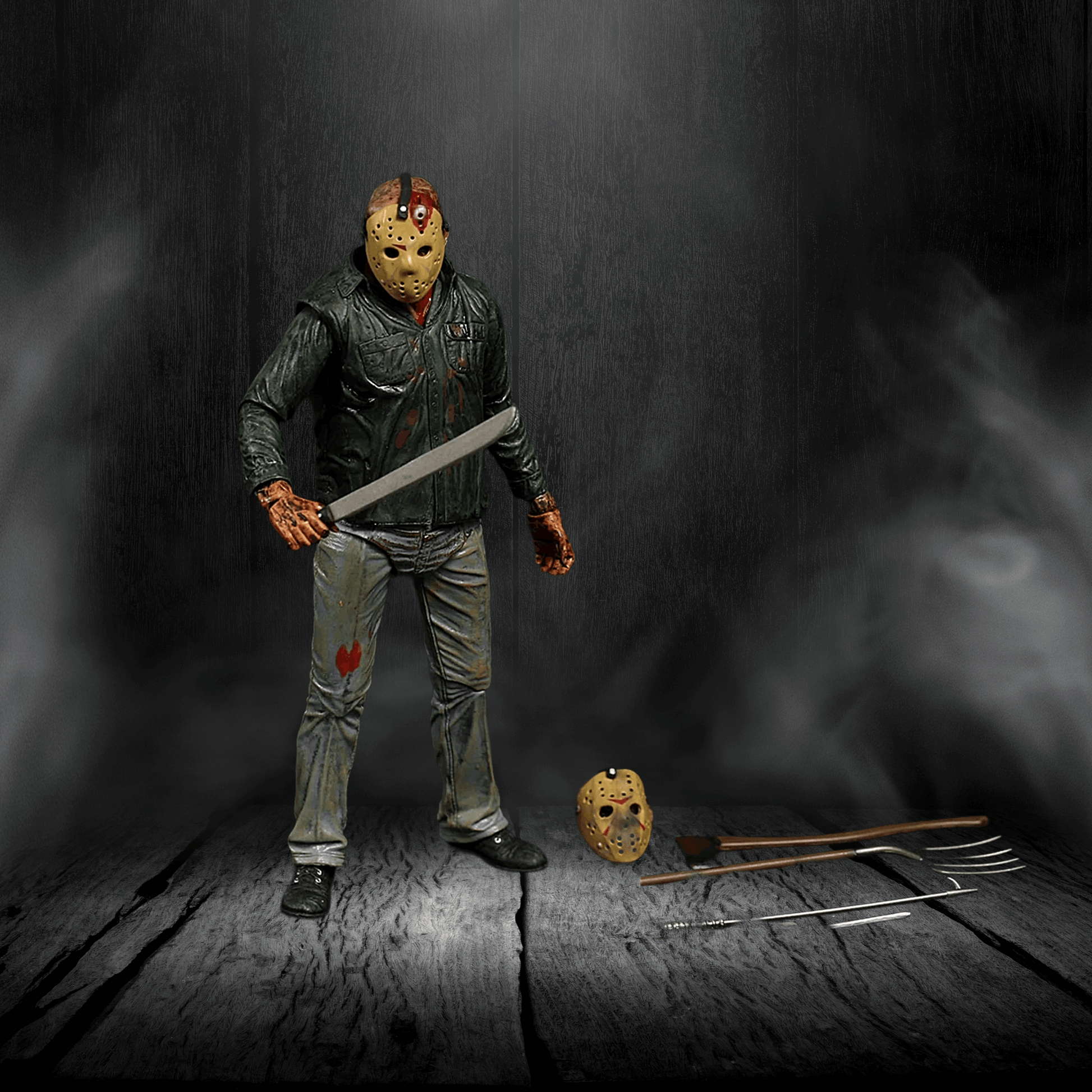 Action figure in a dark setting with a weapon and mask