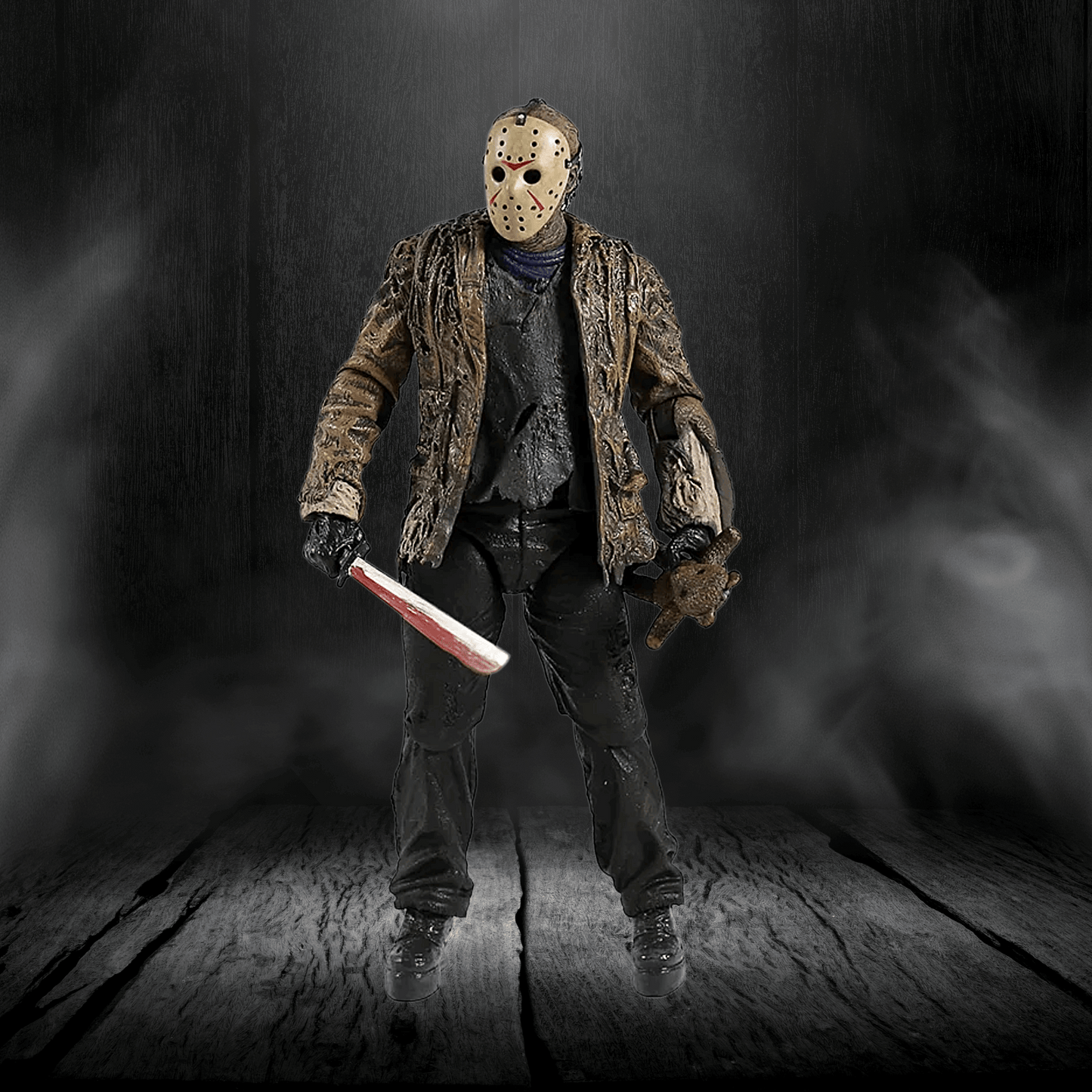 Action figure in a dark, smoky setting holding a knife