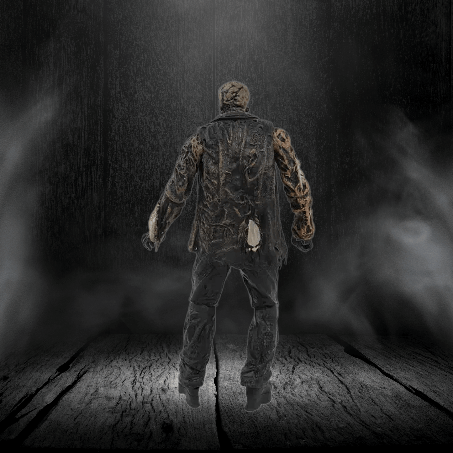 Mannequin in camouflage clothing standing on a wooden floor with a dark, smoky background