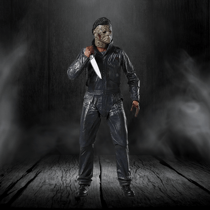 Person in a dark costume holding a knife against a dark background