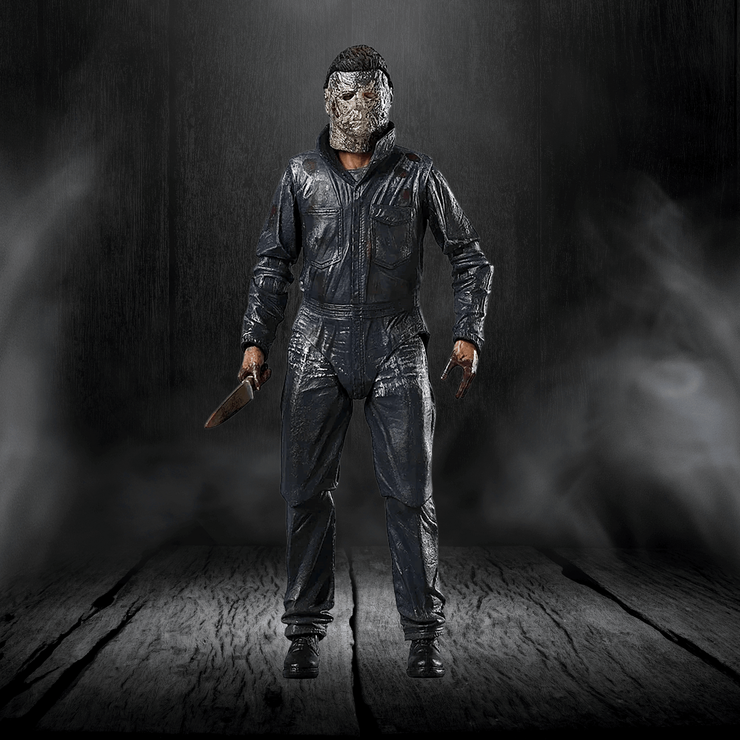 Action figure in a dark, smoky setting holding a knife.