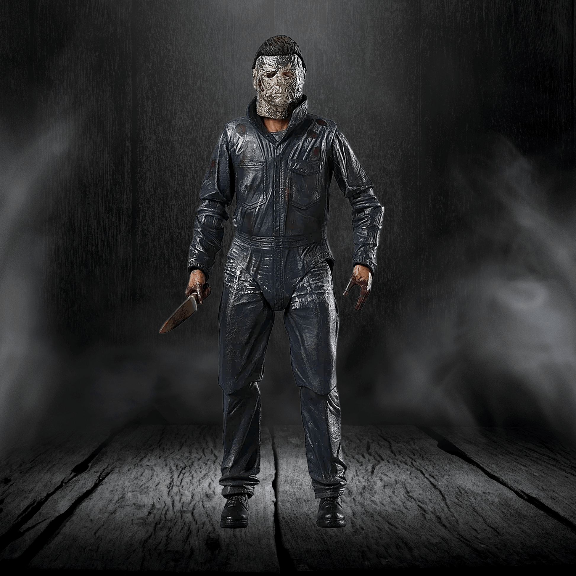 Action figure in a dark, smoky setting holding a knife.