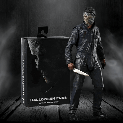 Action figure of a character from 'Halloween Ends' next to its packaging on a dark background