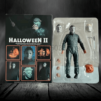 Action figure of Michael Myers from 'Halloween II' next to its packaging on a wooden surface.