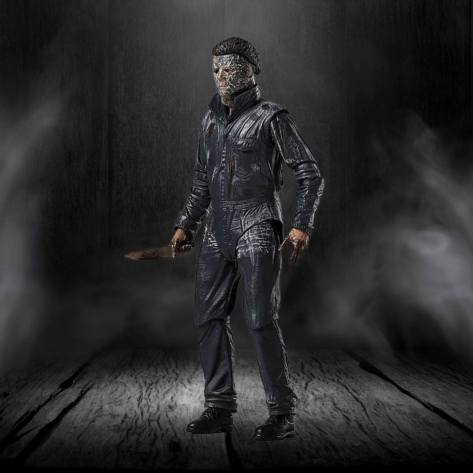 Action figure in a dark, smoky setting holding a knife.