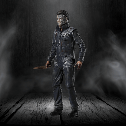 Action figure in a dark, smoky setting holding a knife.