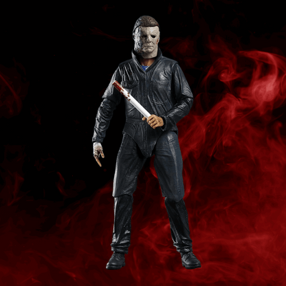 Action figure in a dark suit with a knife against a red and black background